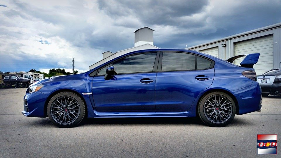 shiny four door sedan with a spoiler